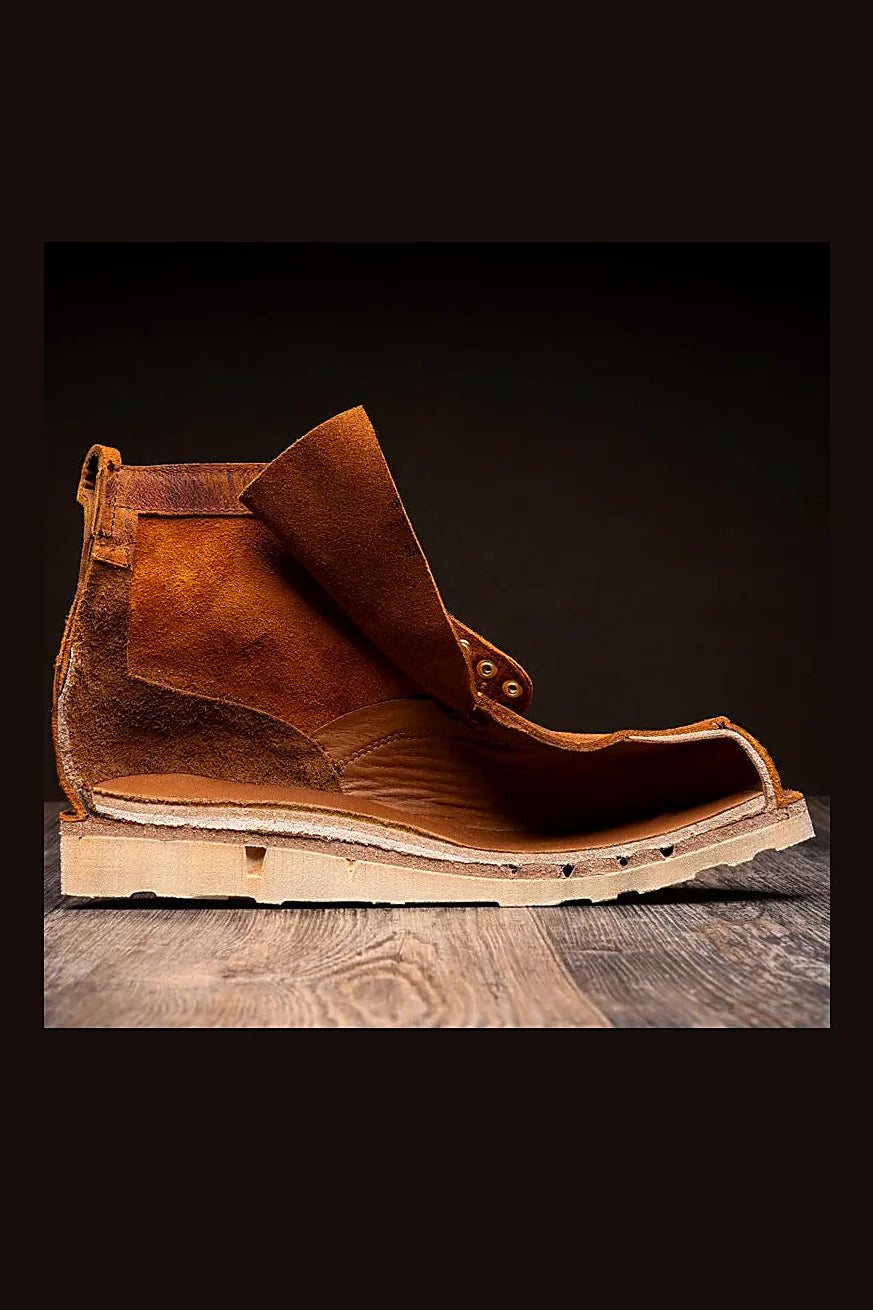 Golden boot with leather reinforcement